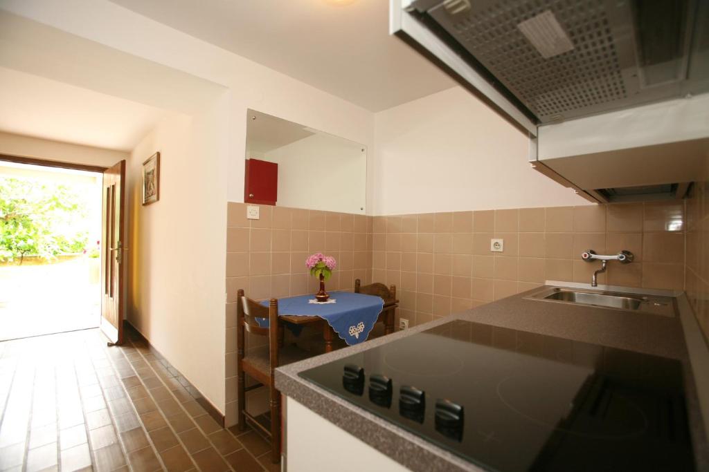 a kitchen with a sink and a counter top at Apartments Neda - Poreč South in Poreč