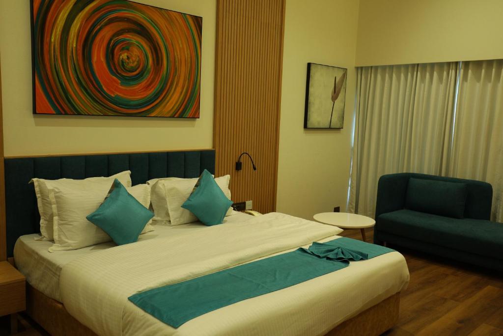 Postel nebo postele na pokoji v ubytování Hotel Blueivy Anand
