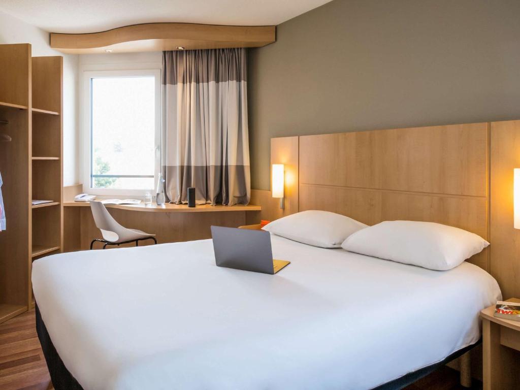 Postel nebo postele na pokoji v ubytování ibis Lausanne Crissier
