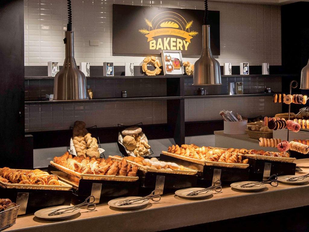 a bakery with many different types of pastries on display at Almar Timi Ama Resort & Spa in Villasimius