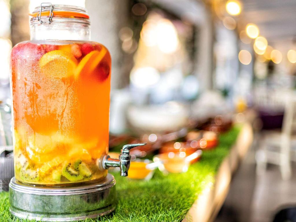 a mason jar filled with fruit on a table at Almar Timi Ama Resort & Spa in Villasimius
