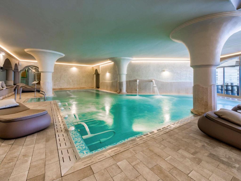 a swimming pool in a hotel with a pool at Almar Timi Ama Resort & Spa in Villasimius