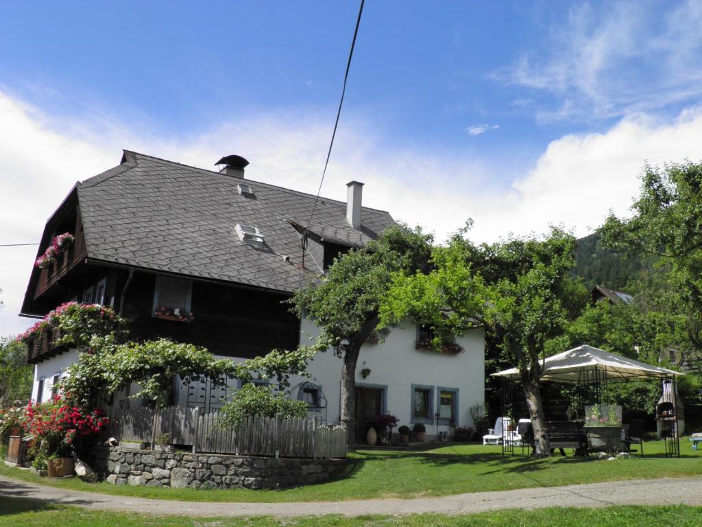 a white house with a black roof at Haus Hanshois in Millstatt