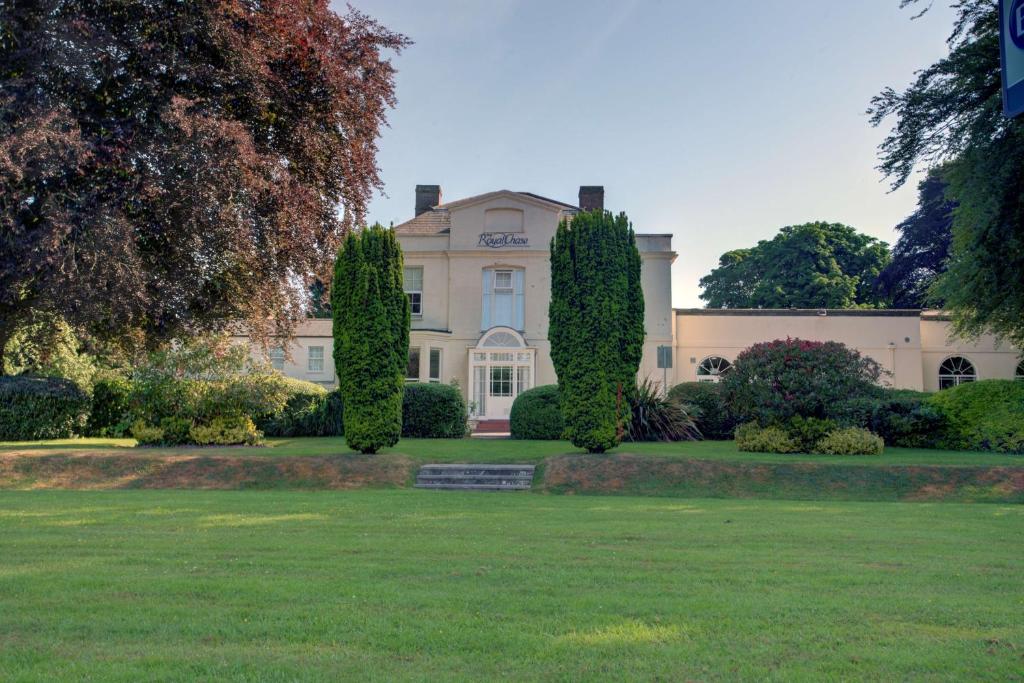 a large house with trees in front of it at Best Western The Royal Chase Hotel in Shaftesbury