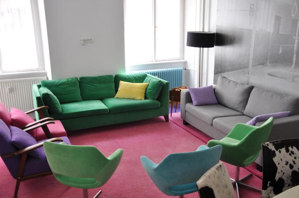 a living room with couches and chairs at Munda house Big design family friendly 4BR apt in Ljubljana