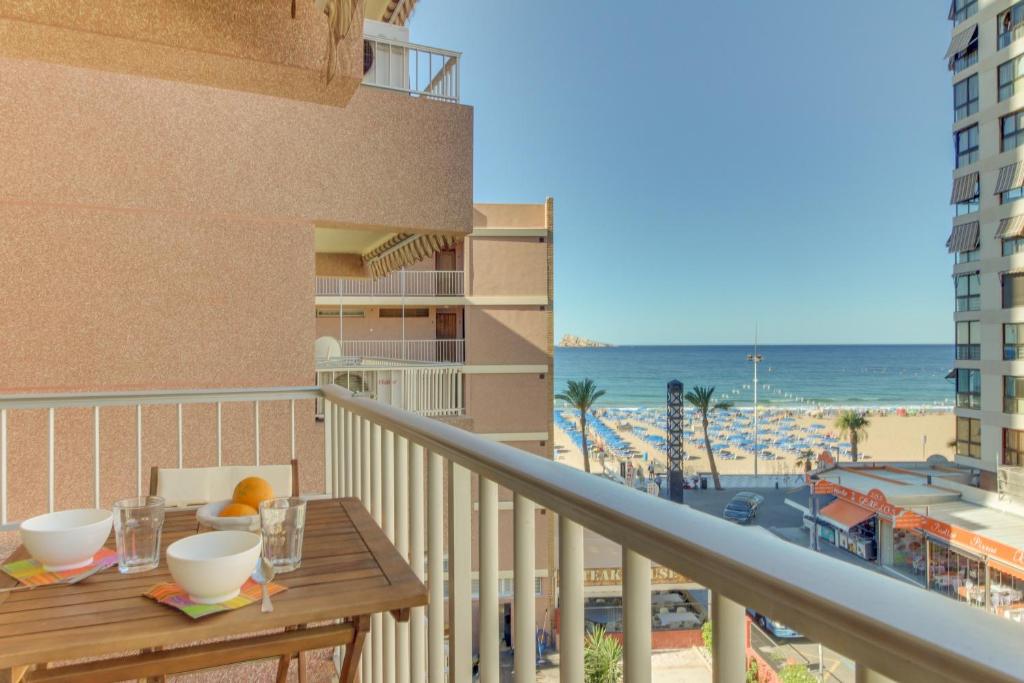 a balcony with a table and a view of the beach at Ranchos Apartment in Benidorm