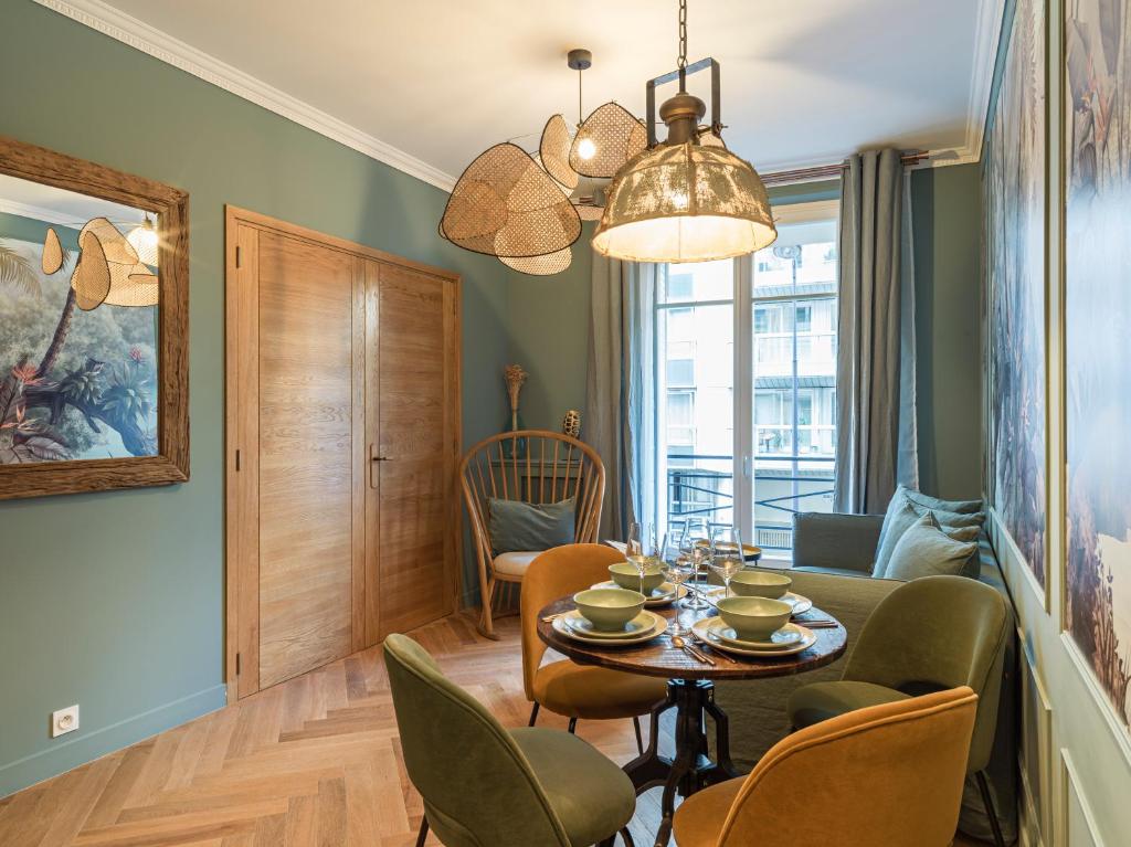 a dining room with a table and chairs at Nature and Haven of Peace Apartment in Paris
