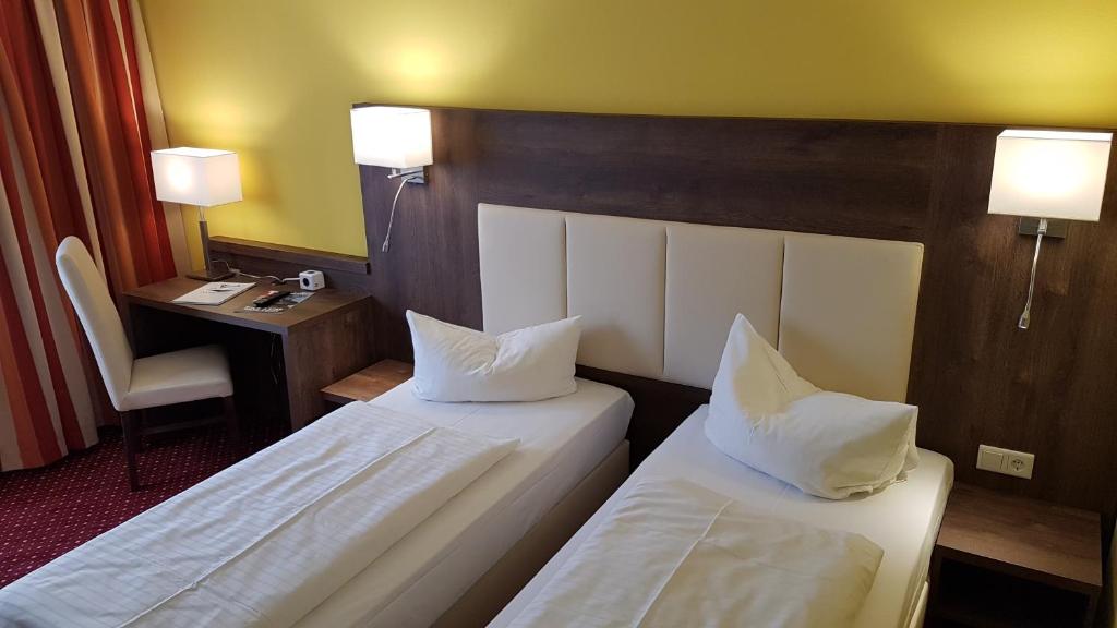 Postel nebo postele na pokoji v ubytování INVITE Hotel Nürnberg City