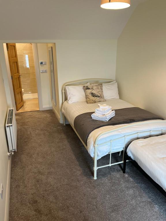 a small bedroom with a bed and a hallway at Old Irish farmhouse in Dingle
