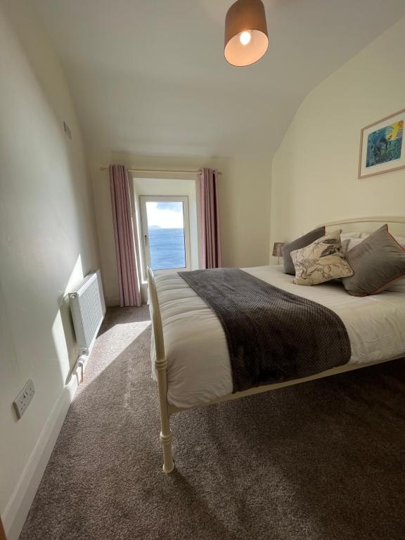 a bedroom with a large bed and a window at Old Irish farmhouse in Dingle
