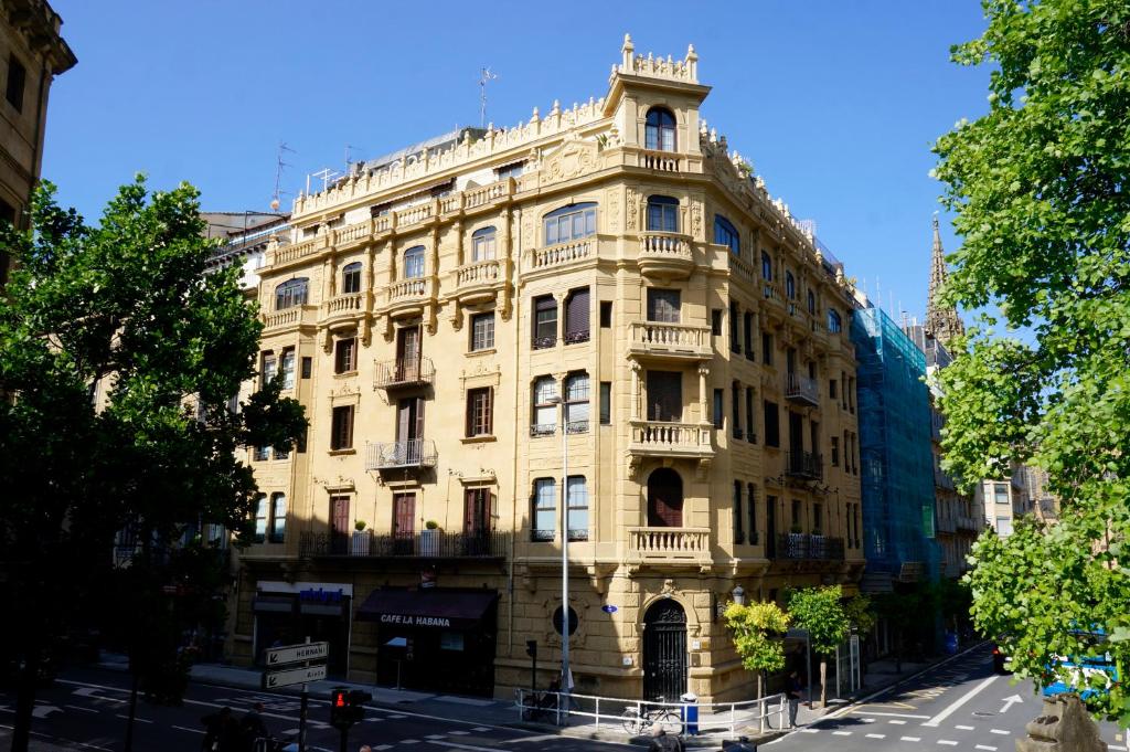 a large yellow building on a city street at Loaldia in San Sebastián