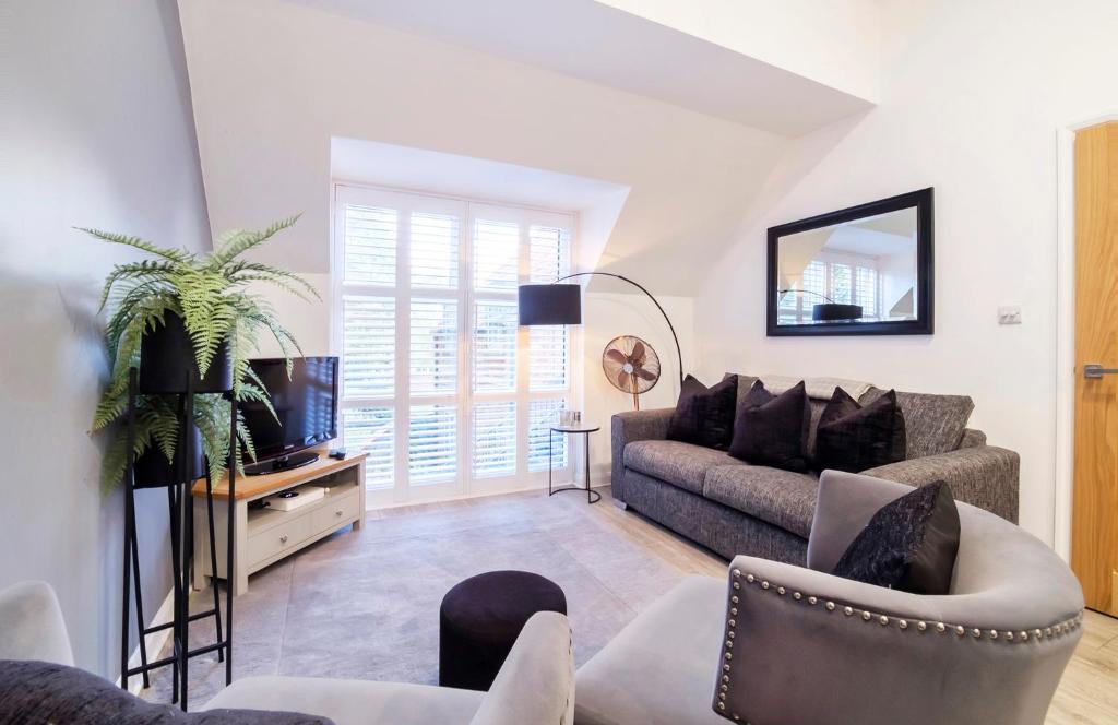 a living room with a couch and a tv at Minster's Reach York close to York Minster in York