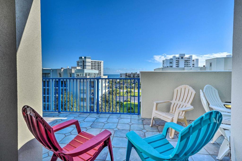 three chairs and a table on a balcony at Coastal Penthouse Steps to New Smyrna Beach! in New Smyrna Beach