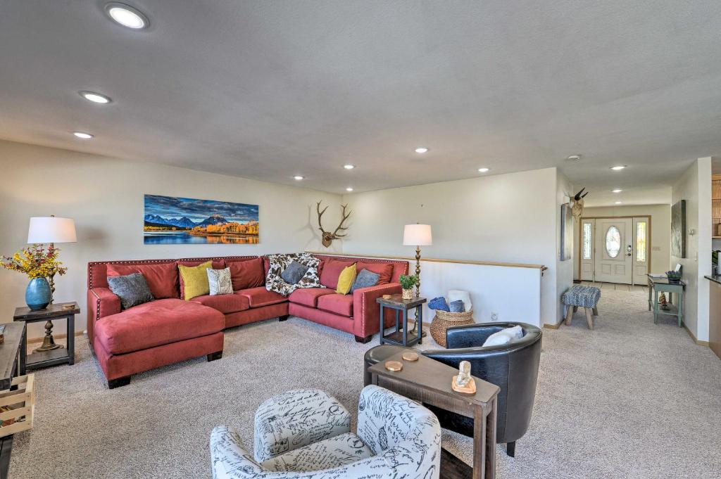 a living room with a red couch and chairs at Outdoor Enthusiasts Retreat with Hot Tub, Deck in Lander