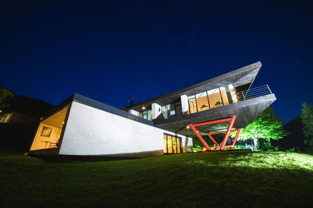 a house with a cube like facade at night at Pensiunea Atra Doftana in Teşila