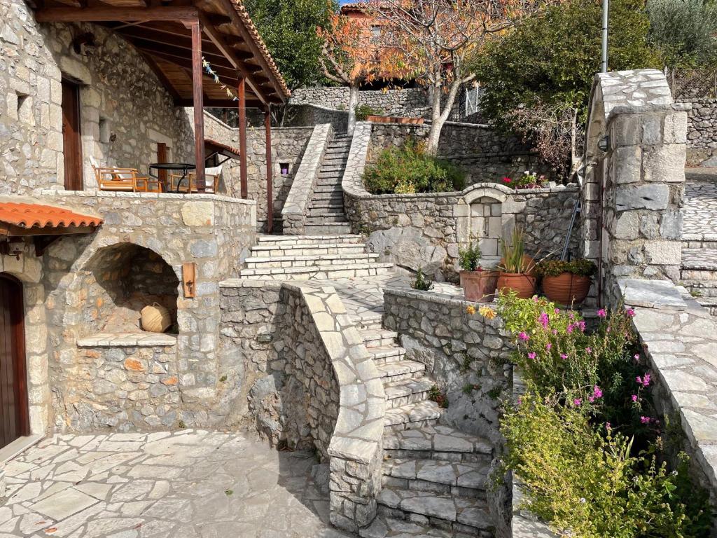 a stone stairway leading to a house with a stone oven at Terra Petra Villa at Psari Trikolonon Gortynia in Psárion