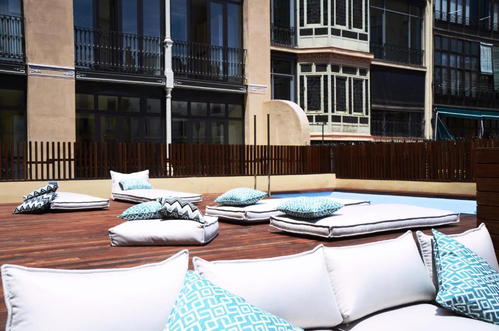 a group of pillows sitting on a wooden table with buildings at TOC Hostel Barcelona in Barcelona