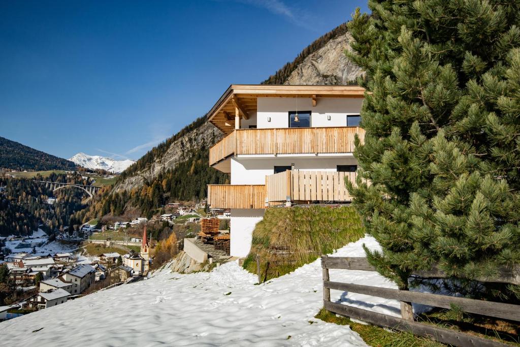 a house on top of a snow covered mountain at Ferienwohnung Katarina in Vals