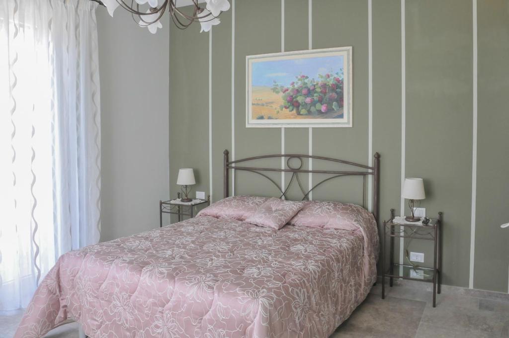 Łóżko lub łóżka w pokoju w obiekcie La Casa dell'Alloro