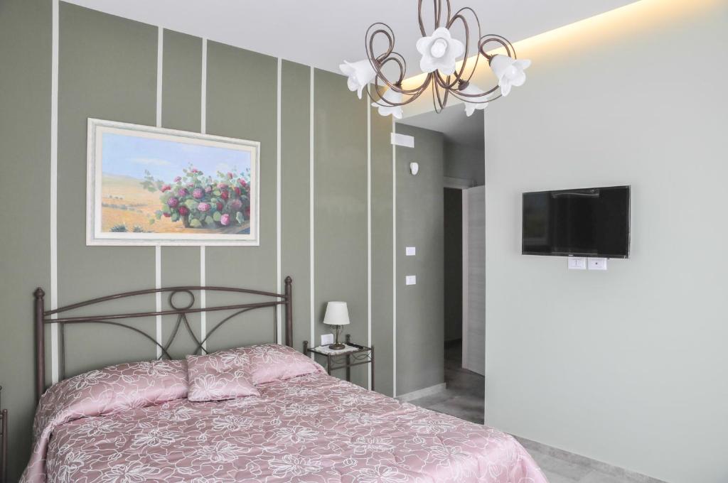 Łóżko lub łóżka w pokoju w obiekcie La Casa dell'Alloro