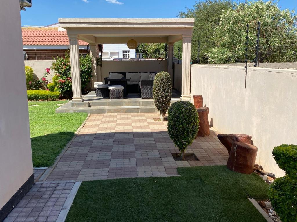 a patio with a gazebo in a yard at Magville Guest House in Gaborone