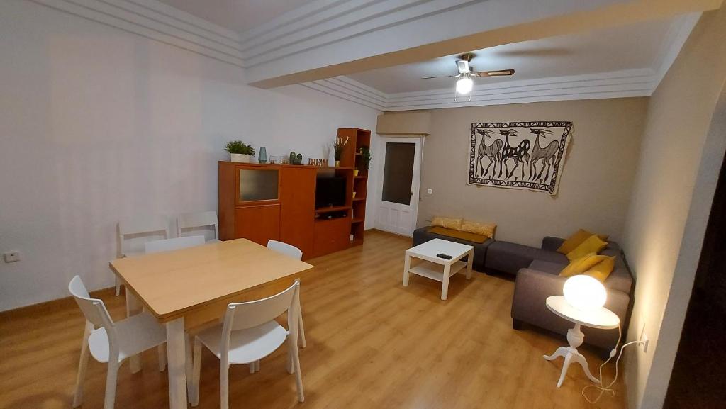 a living room with a table and a couch at Casa Bounty in Los Nietos