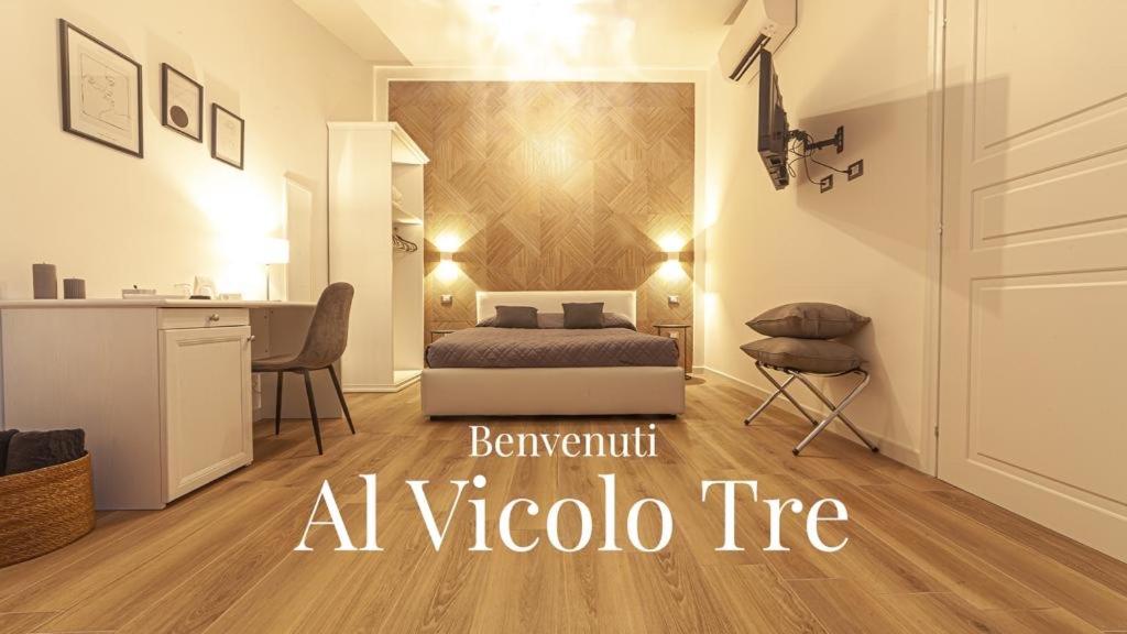 a bedroom with a bed and a desk in a room at Palazzo Lombardi Al Vicolo in Sassari