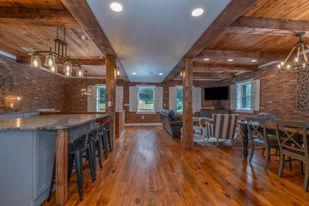 a kitchen with a bar and a living room at The Loft on Trade Street in Tryon