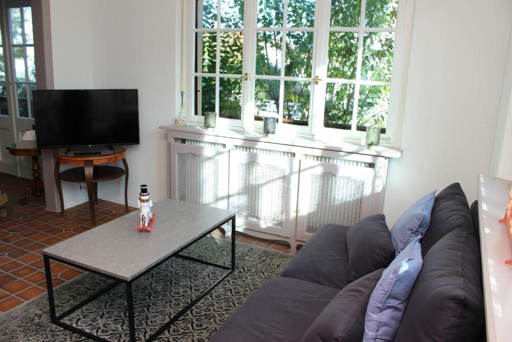 a living room with a couch and a table at Villa Schmitt in Sélestat