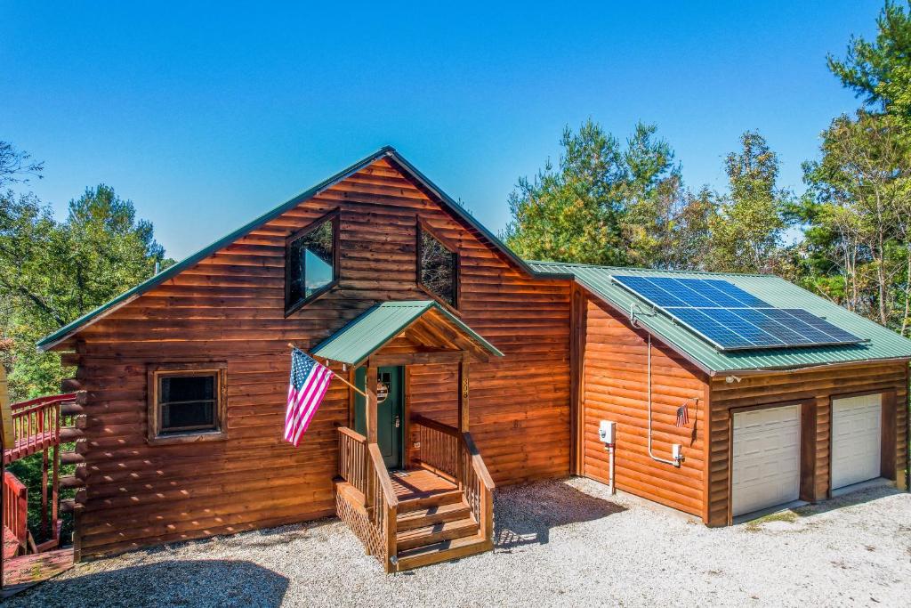 a cabin with solar panels on the roof at Lost Indian Hideaway in Whittier