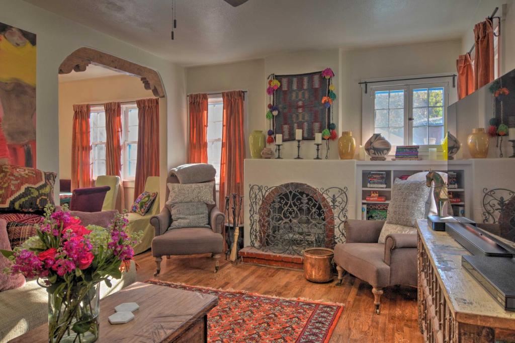 a living room with a fireplace and chairs at Cozy Adobe Casita 1 Mile to Santa Fe Plaza! in Santa Fe