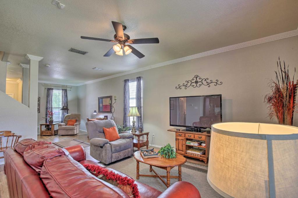 a living room with a couch and a flat screen tv at Hill Country Hideaway with Game Room and Patio! in Dominion