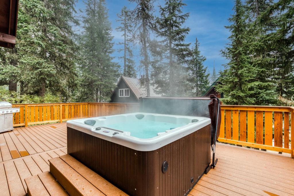 a hot tub on the deck of a house at Blue Pine Chalet in Government Camp