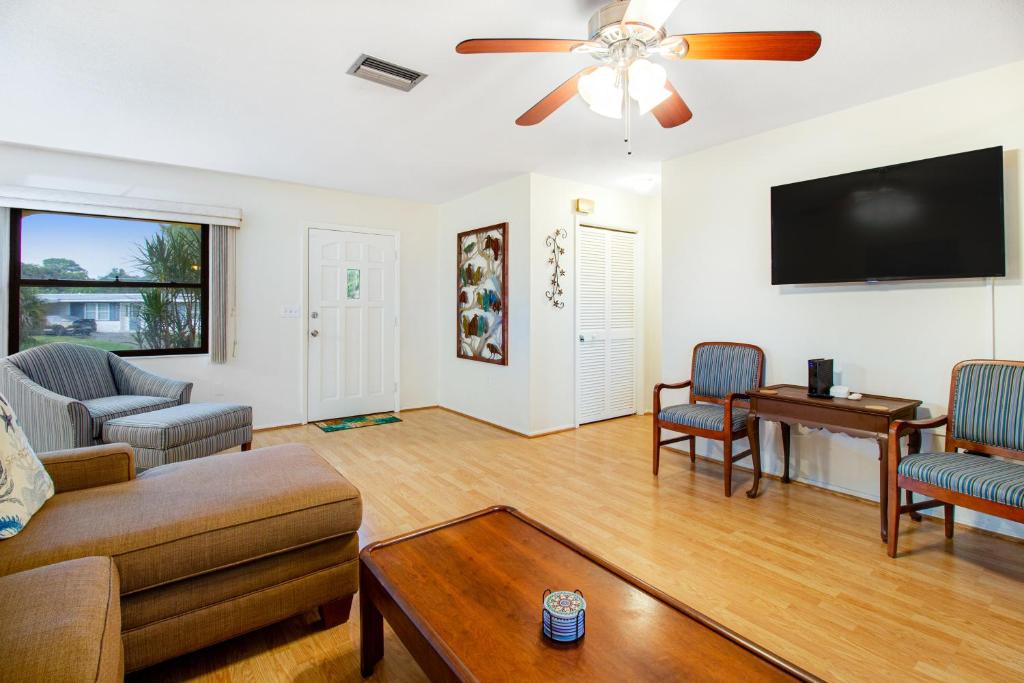 a living room with a couch and a flat screen tv at By the Bay in Sarasota