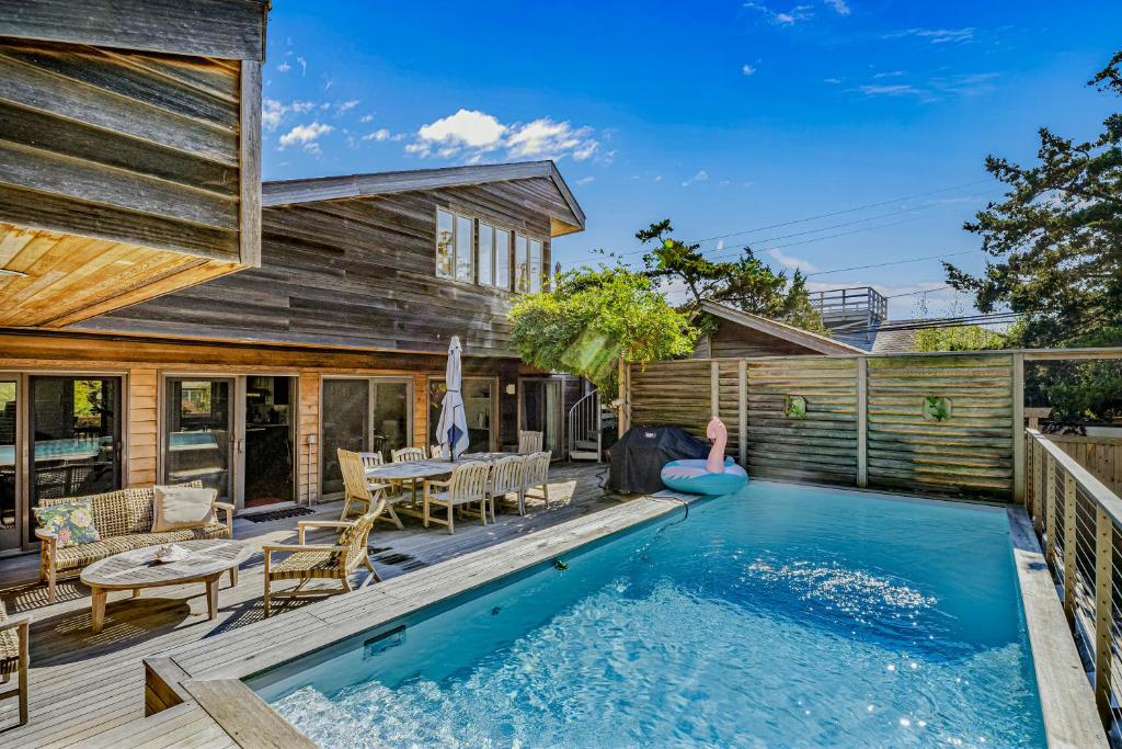 a house with a swimming pool and a patio at Paradiso in Ocean Beach