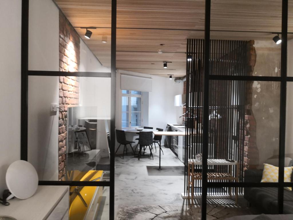 a living room with a table and chairs in a room at Central Ojakatu in Tampere