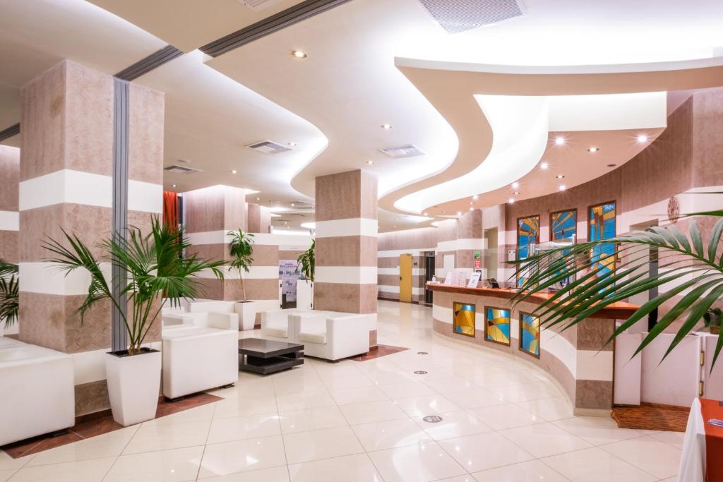 a lobby of a hospital with plants at Konstantinos Palace in Karpathos