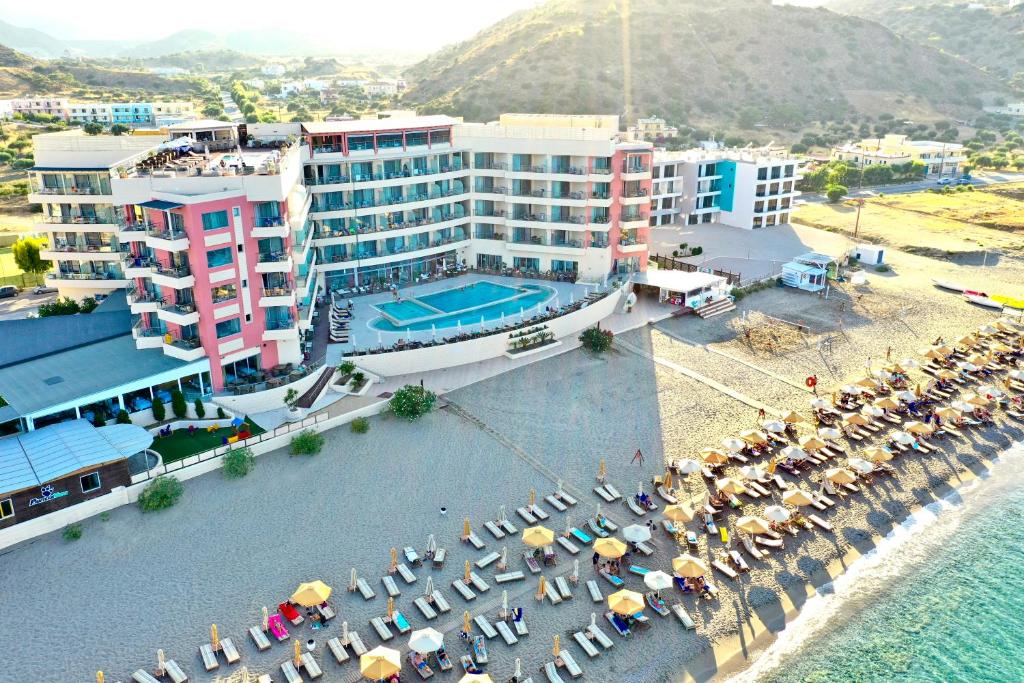 an aerial view of a hotel and a beach with umbrellas at Konstantinos Palace in Karpathos