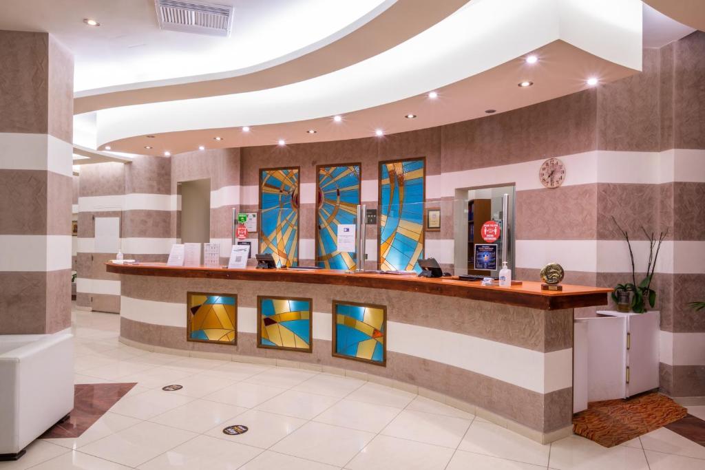 a lobby with a counter with stained glass windows at Konstantinos Palace in Karpathos