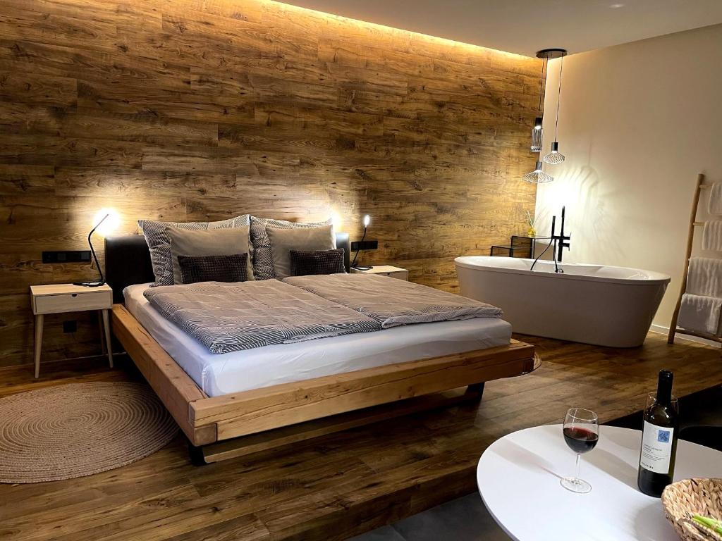 a bedroom with a large bed and a bath tub and a tub at Golden Key Apartments in Liberec