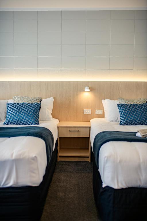 Postel nebo postele na pokoji v ubytování Takapuna International Motor Lodge