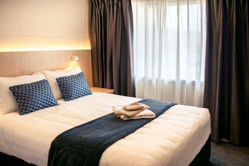 Postel nebo postele na pokoji v ubytování Takapuna International Motor Lodge