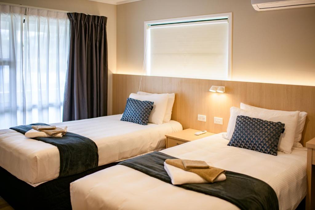Postel nebo postele na pokoji v ubytování Takapuna International Motor Lodge