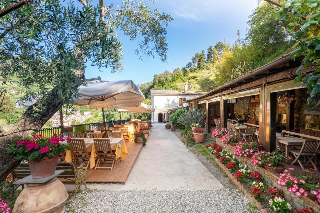 a restaurant with tables and chairs and an umbrella at Agriturismo Buranco in Monterosso al Mare