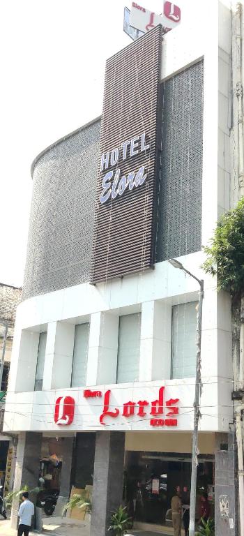a hotel building with a sign on the front of it at Elora Lords Eco Inn , Lucknow in Lucknow