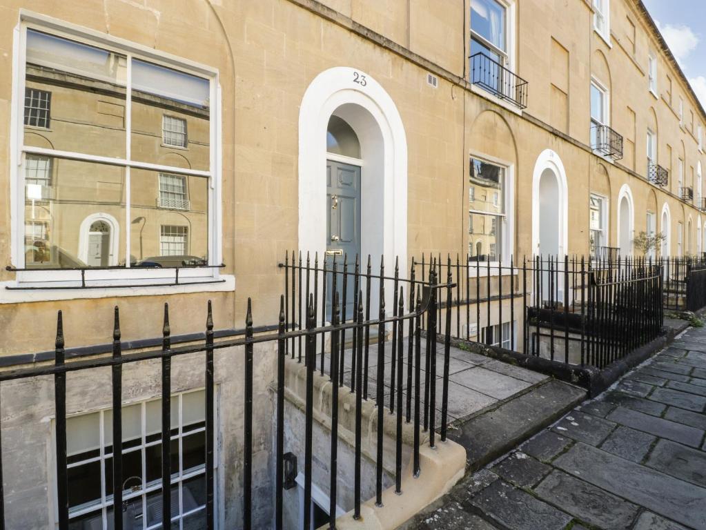 a black fence in front of a building at 23 Daniel Street in Bath