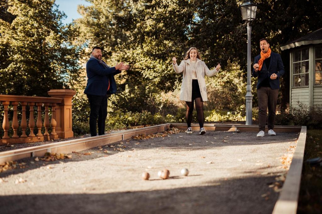 a group of three people standing in a park at Hotel Hasselbacken in Stockholm