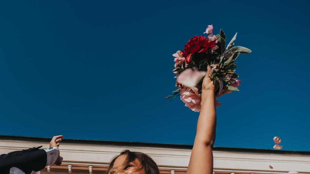 a person holding up a bouquet of flowers at Hotel Hasselbacken in Stockholm