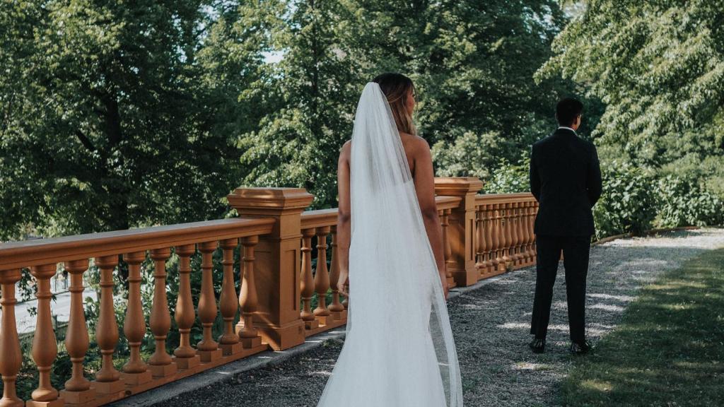 a bride and groom standing on a bridge at Hotel Hasselbacken in Stockholm