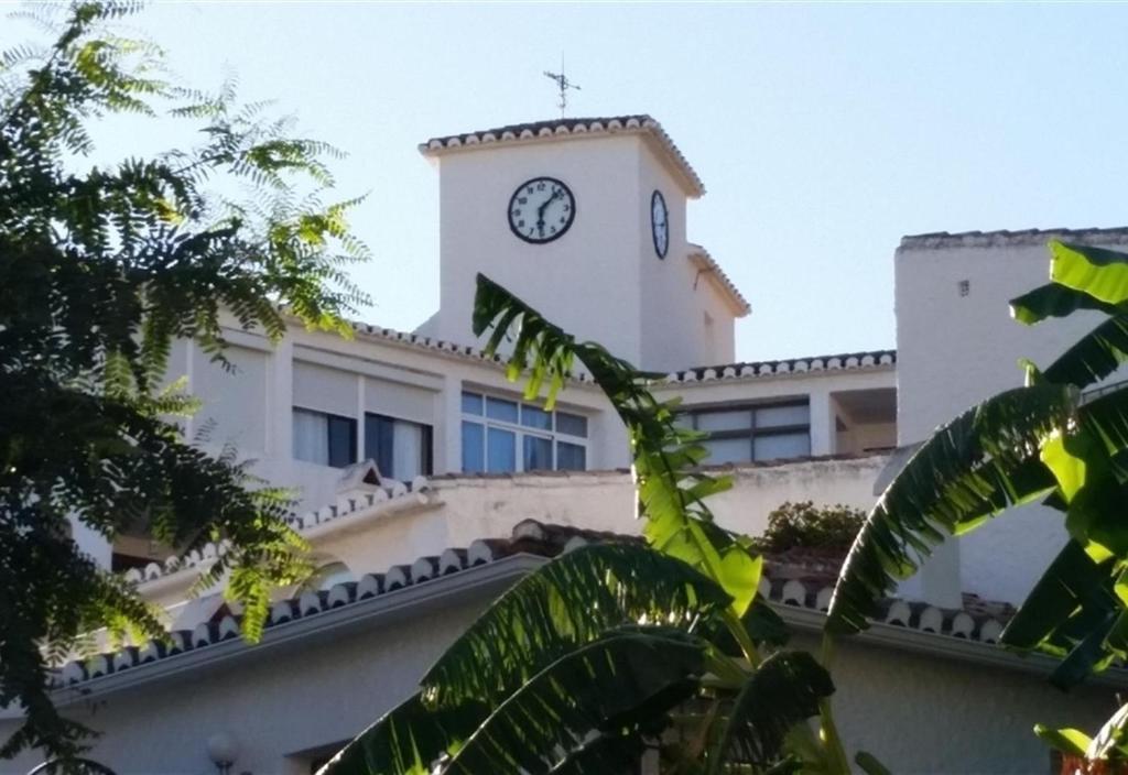 un bâtiment avec une tour d'horloge en haut dans l'établissement Holiday apartment in Torreblanca, à Fuengirola